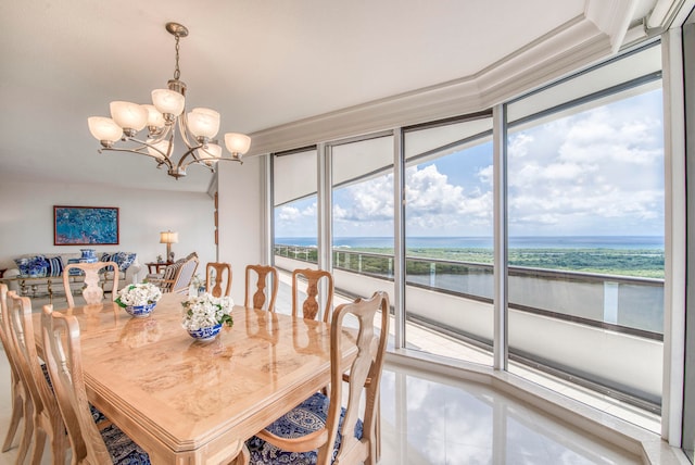 tiled dining room featuring a chandelier, a water view, and a healthy amount of sunlight