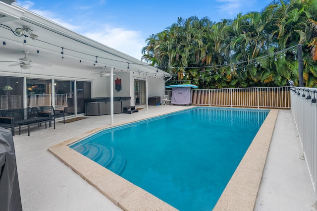 view of swimming pool with a patio and ceiling fan