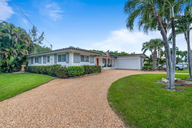 single story home with a garage and a front yard