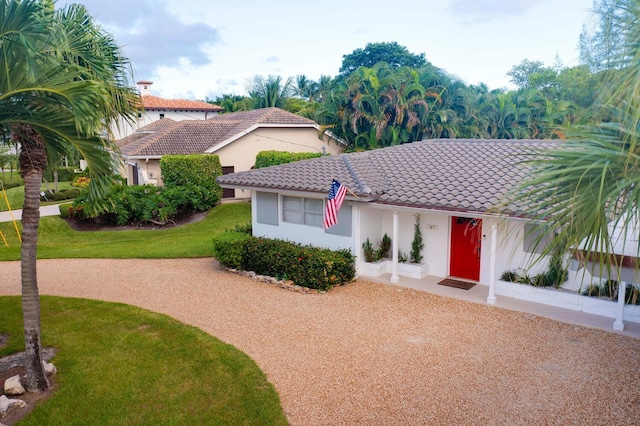 mediterranean / spanish-style home with a front yard