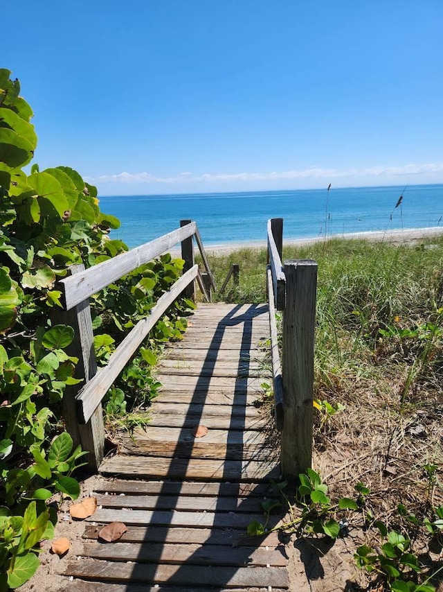 view of property's community featuring a view of the beach and a water view