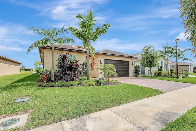 view of front of house featuring a garage and a front lawn