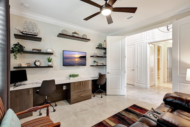 tiled office space with ceiling fan, built in desk, and ornamental molding