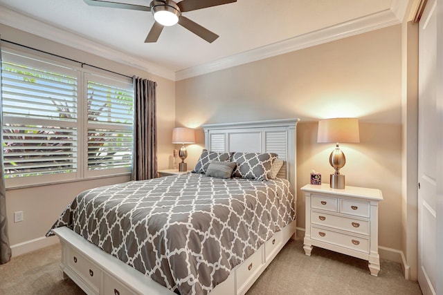 carpeted bedroom featuring ornamental molding and ceiling fan