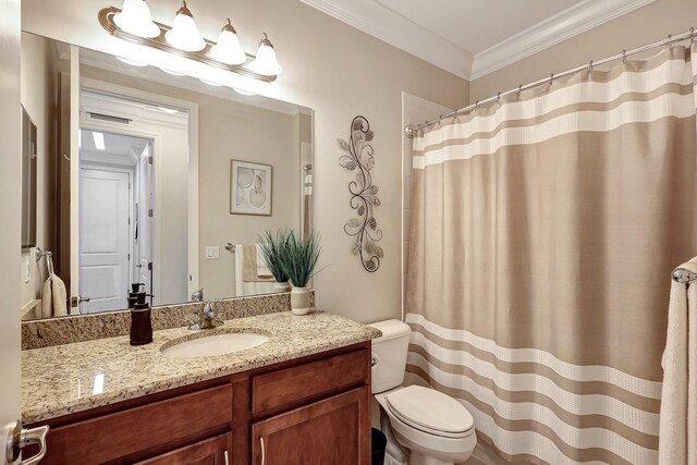 bathroom featuring ornamental molding, a shower with shower curtain, vanity, and toilet