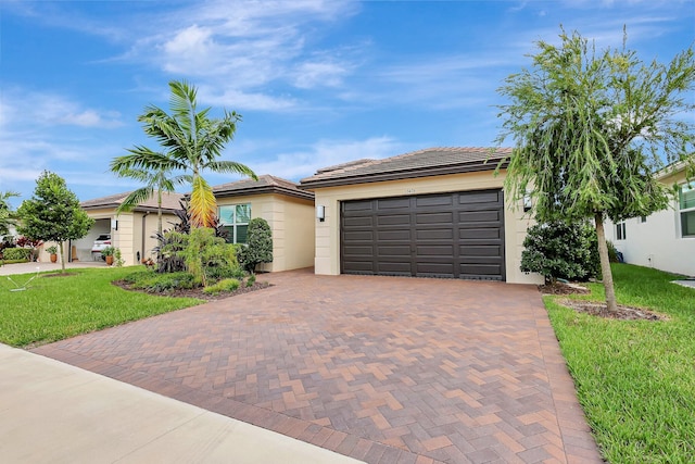 ranch-style home with a garage and a front lawn