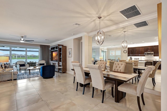 dining area featuring ceiling fan with notable chandelier and ornamental molding