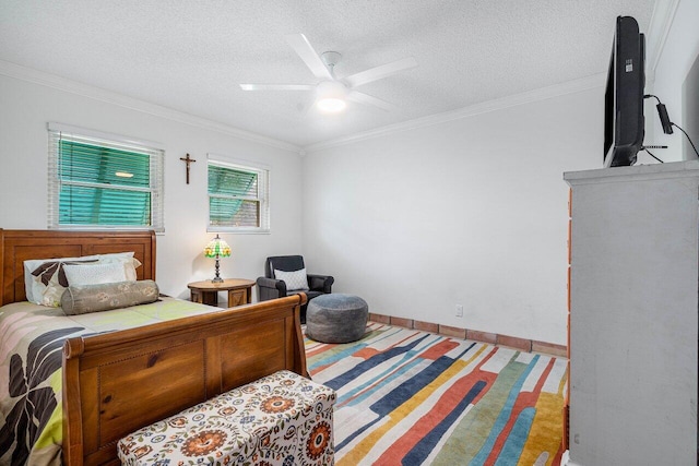 bedroom with a textured ceiling, ceiling fan, and crown molding