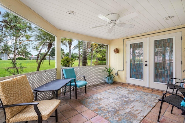 sunroom featuring ceiling fan, wood ceiling, and french doors