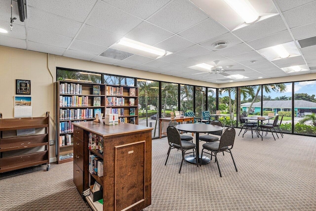 office area featuring a paneled ceiling, ceiling fan, and light colored carpet