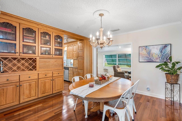 dining area with a chandelier, crown molding, dark wood-type flooring, and a textured ceiling