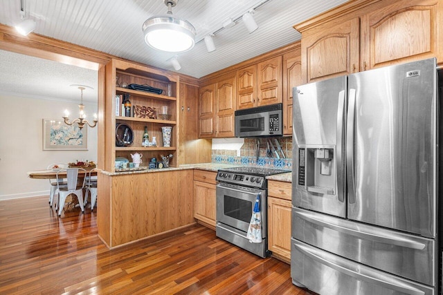 kitchen with appliances with stainless steel finishes, rail lighting, and dark hardwood / wood-style floors