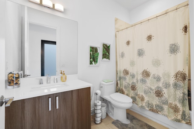 full bathroom with vanity, toilet, and shower / tub combo