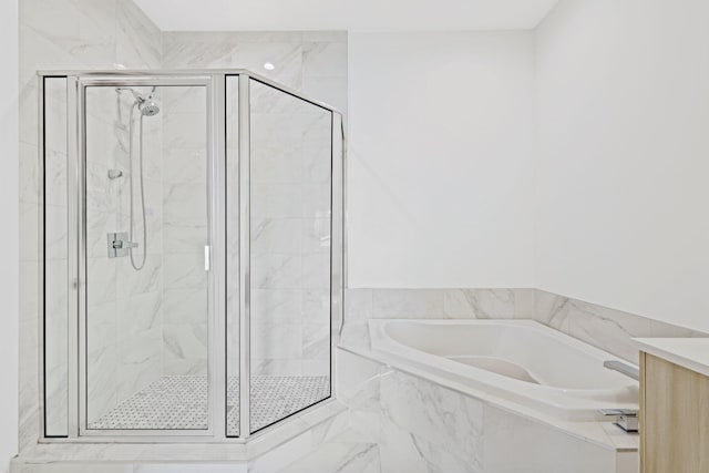 bathroom with independent shower and bath and vanity