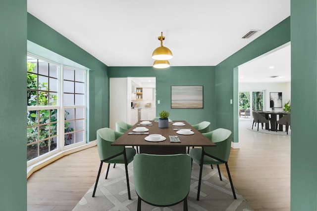 dining area with plenty of natural light and light wood-type flooring