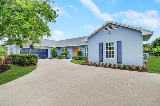 ranch-style home with a front lawn and a garage