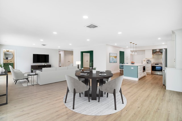 dining room with light hardwood / wood-style flooring