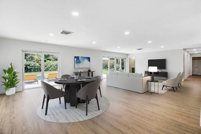 dining room featuring plenty of natural light and light hardwood / wood-style floors