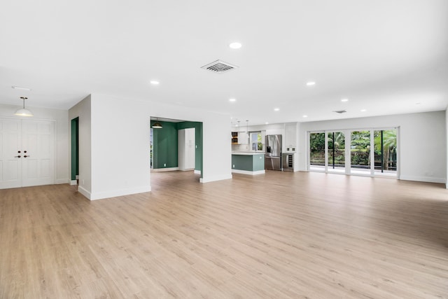 unfurnished living room featuring light hardwood / wood-style floors