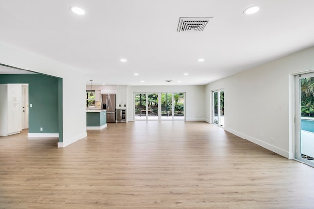 unfurnished living room with light hardwood / wood-style flooring