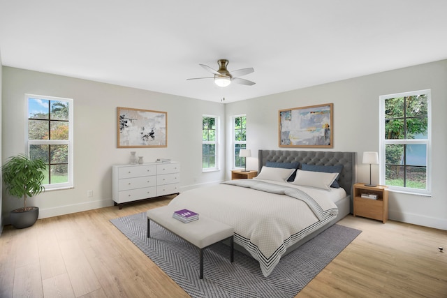 bedroom with ceiling fan and light hardwood / wood-style flooring