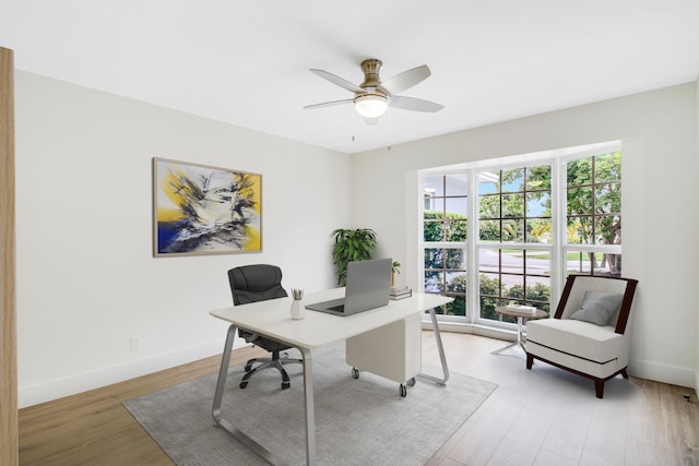 office area with light wood-type flooring and ceiling fan