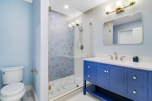 bathroom with vanity, a shower with shower door, and toilet