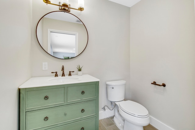 bathroom with wood-type flooring, vanity, and toilet