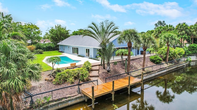 rear view of house with a water view and a patio