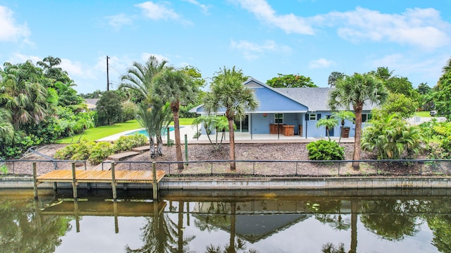 view of dock featuring a water view, a pool, and a patio area