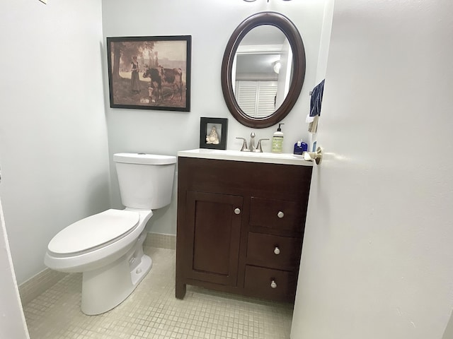 270 Tilford M, Deerfield Beach, FL 33442 - half bathroom featuring toilet, vanity, tile patterned floors, and baseboards