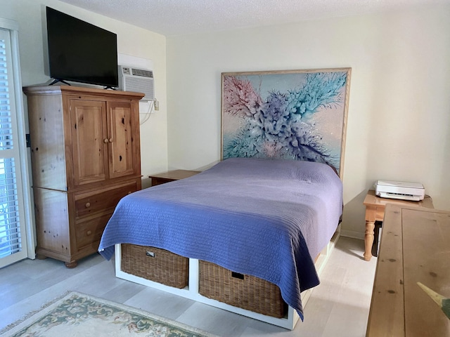 270 Tilford M, Deerfield Beach, FL 33442 - bedroom with light wood-type flooring and a wall unit AC