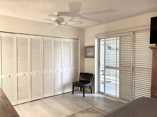 270 Tilford M, Deerfield Beach, FL 33442 - bedroom with a textured ceiling, light wood finished floors, a closet, and a ceiling fan