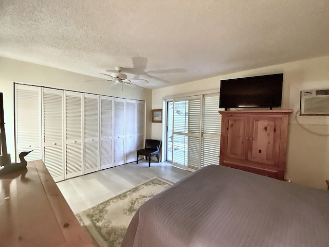 270 Tilford M, Deerfield Beach, FL 33442 - bedroom featuring light wood-style floors, a textured ceiling, ceiling fan, and a wall mounted AC