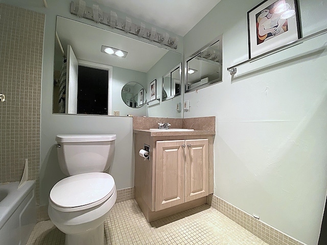 270 Tilford M, Deerfield Beach, FL 33442 - full bathroom with vanity, toilet, tile patterned floors, baseboards, and shower / bathtub combination