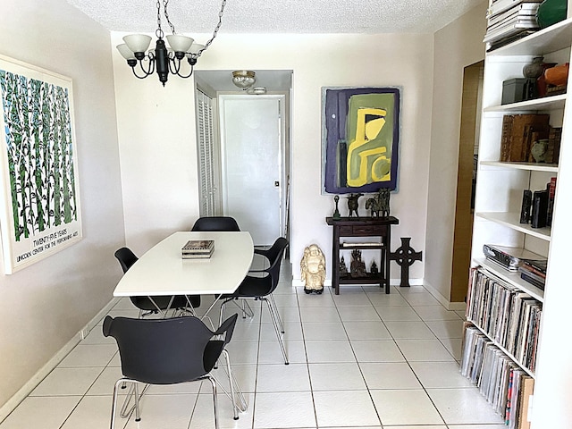 270 Tilford M, Deerfield Beach, FL 33442 - dining room featuring a chandelier, a textured ceiling, light tile patterned floors, and baseboards