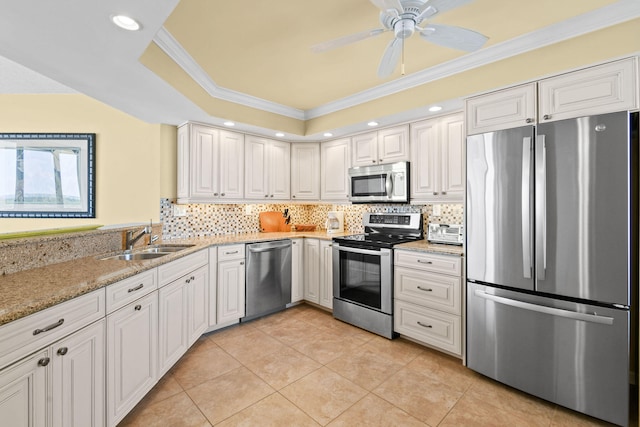 kitchen featuring appliances with stainless steel finishes, white cabinets, crown molding, ceiling fan, and sink