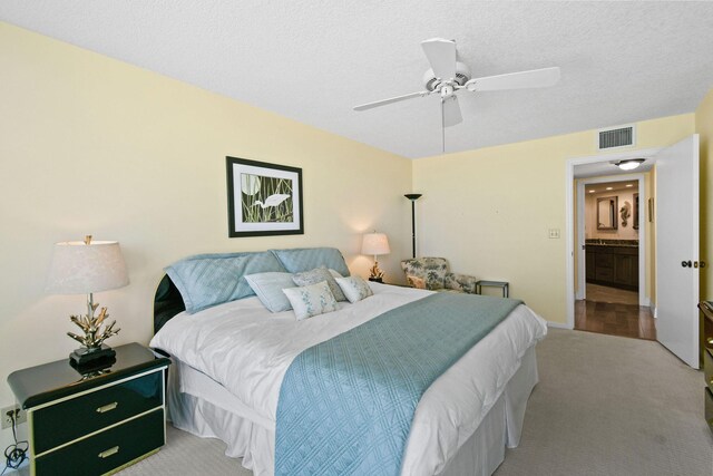 carpeted bedroom with a textured ceiling and ceiling fan