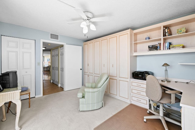 office area with ceiling fan and light colored carpet