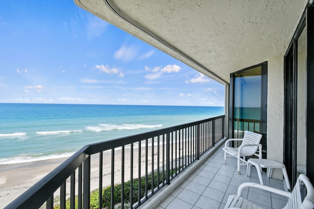 balcony with a view of the beach and a water view