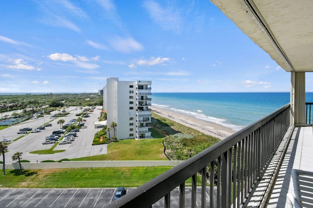 balcony featuring a water view and a view of the beach