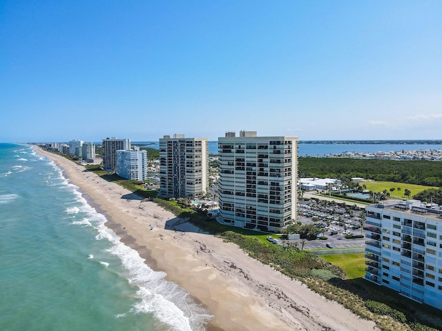 bird's eye view featuring a water view and a beach view