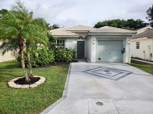 view of front of home featuring a front lawn and a garage