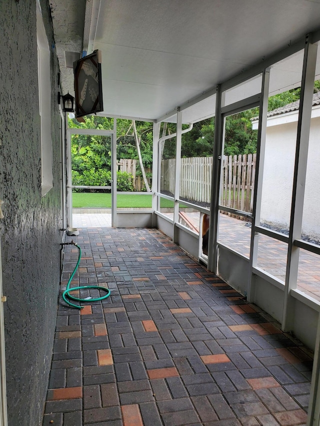 unfurnished sunroom with a wealth of natural light