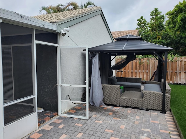 view of patio with a gazebo and a sunroom