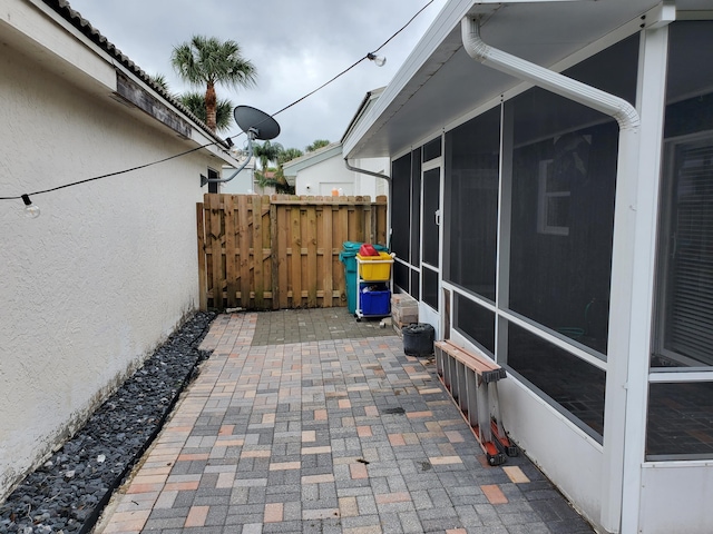 view of patio with a sunroom