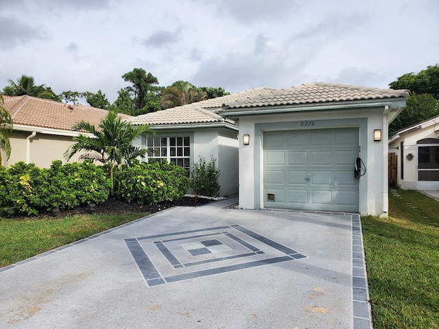 view of front facade featuring a garage and a front lawn