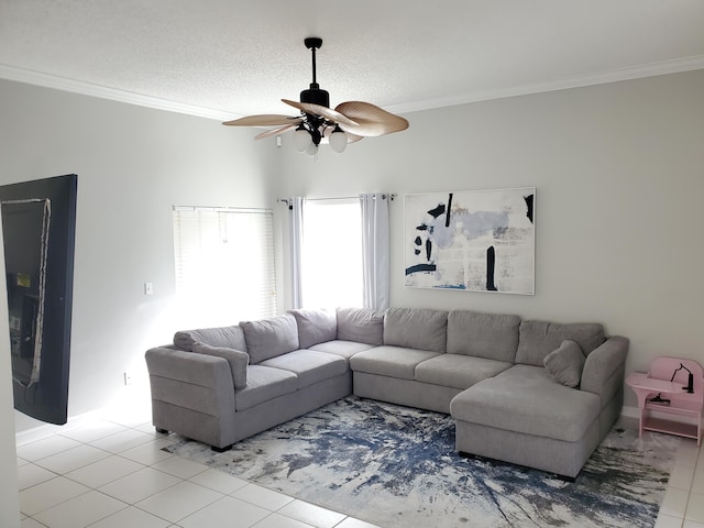 tiled living room with ceiling fan, a textured ceiling, and ornamental molding