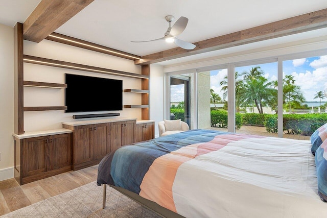 bedroom featuring beamed ceiling, light wood-type flooring, and ceiling fan