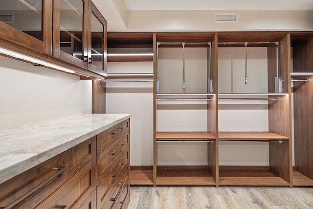 spacious closet featuring light hardwood / wood-style flooring